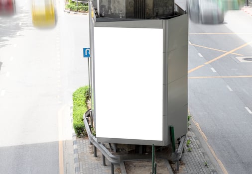 Outdoor pole LED display billboard with mock up white screen on footpath. clipping path for mockup photo