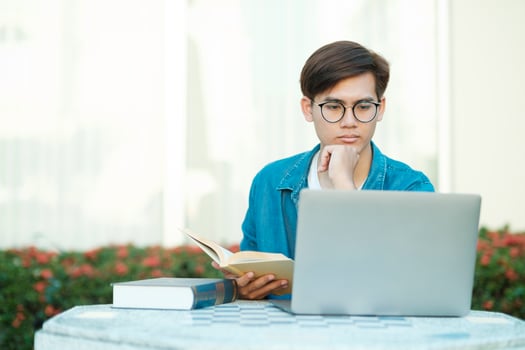 Student studying outdoor using laptop. photo
