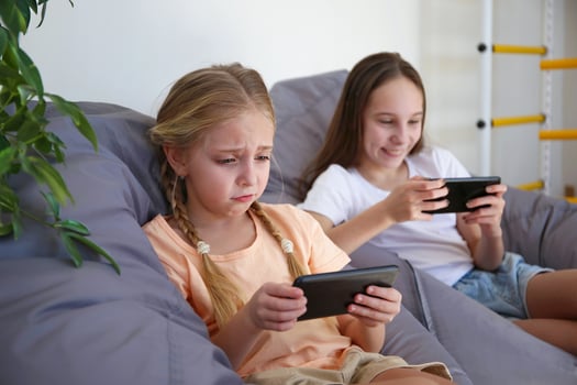 Children play with a mobile phone at home photo