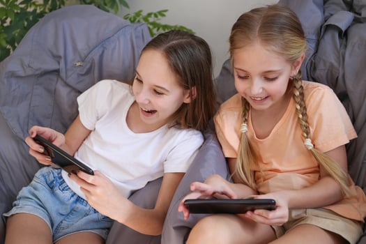 Children play with a mobile phone at home photo