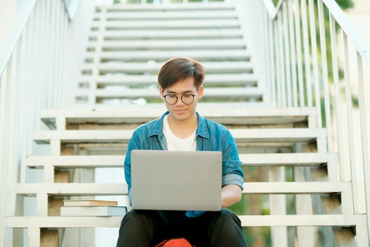 Student studying outdoor using laptop. photo