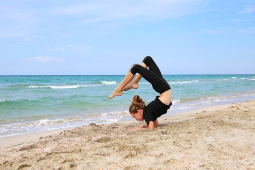 Girl doing sports exercises on the beach. photo