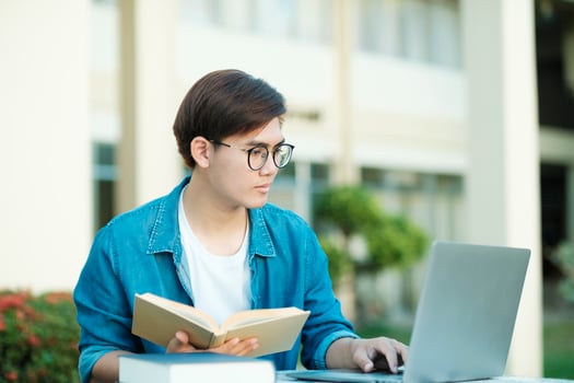 Student studying outdoor using laptop. photo