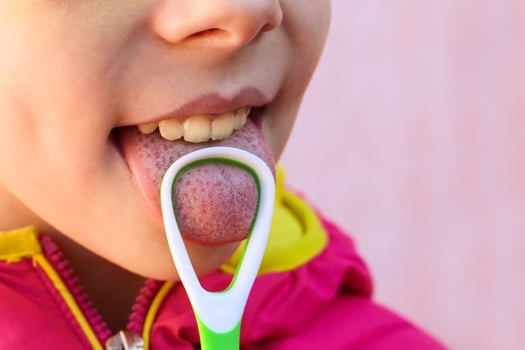 Child brushing his tongue photo