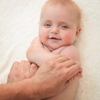 masseur doing exercise for hands little baby photo