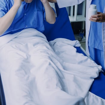 doctor check up after surgery. doctor touching patient hand and consoling. photo