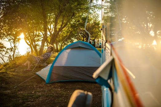 Female Traveler Relaxing Outside Of Camper Van. photo