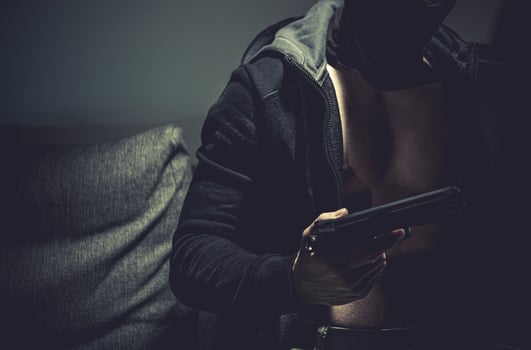 Caucasian Gangster Wearing Black Hoodie with Handgun photo
