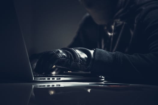 Masked Computer Hacker In Dark Room. photo