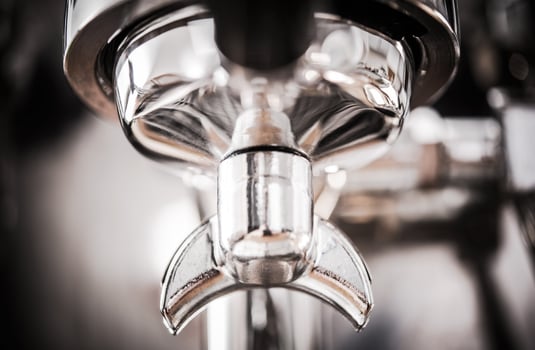 Silver Portafilter Connected To Coffee Machine. photo