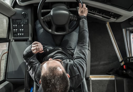 Coach Bus Driver Behind the Vehicle Talking to Vehicle Intercom Wheel Top View photo