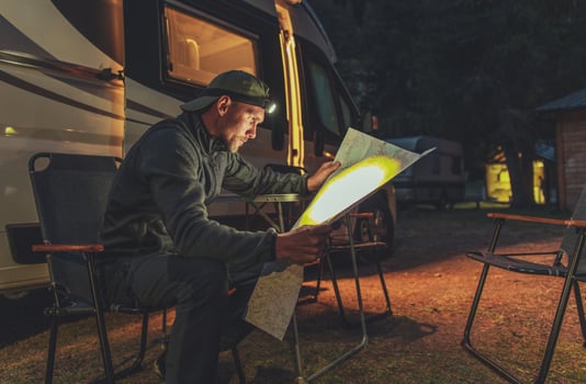 Planning Next Day Trip in Front of His Camper Van photo