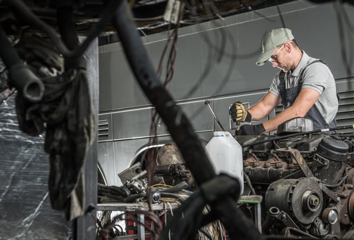 Automotive Technician Repairs Vehicle Diesel Engine photo