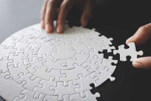 Jigsaw connection a jigsaw in the hands of a businessman Business team assembling a jigsaw puzzle Business and teamwork concept. photo