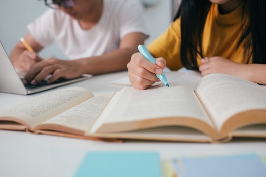 Close up an asian students are reading books and study, Tutoring together. photo
