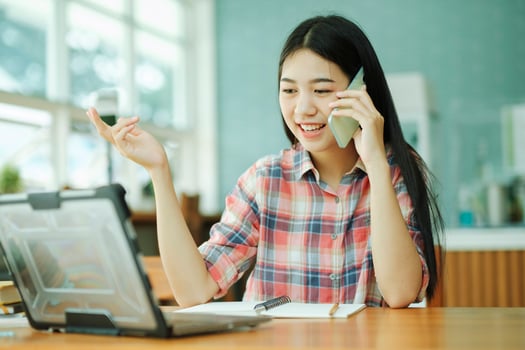 Young businesswoman talking with customer on mobile phone. photo
