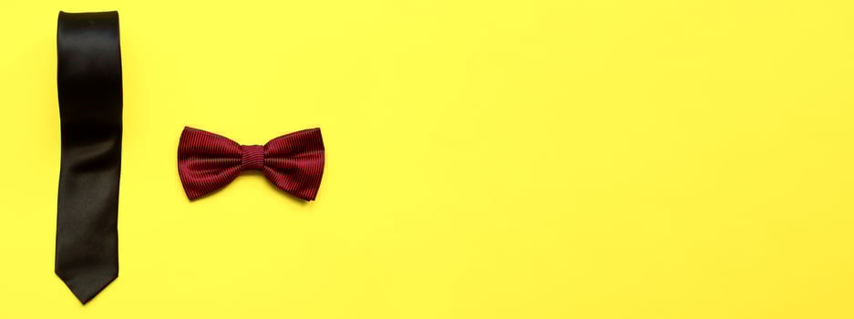 Banner Flat lay bow tie and necktie on a yellow background. Happy fathers day. Male attributes photo
