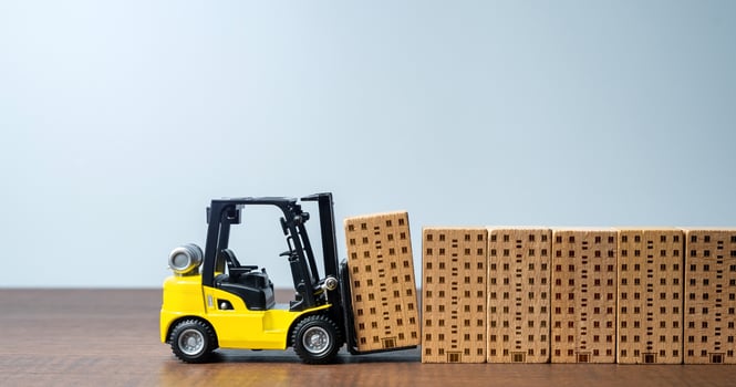 Forklift builds apartment residential buildings. Construction industry. Providing housing infrastructure for growing communities. Progress and development. New housing options become available photo