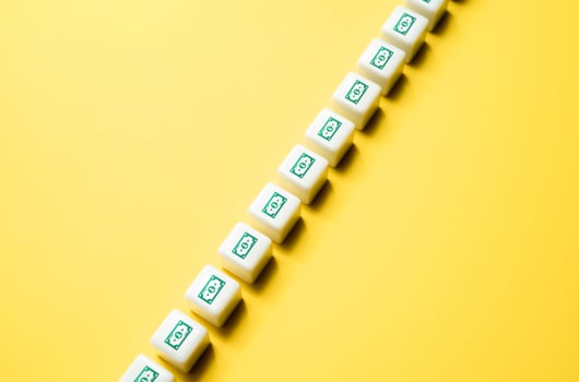 Cash flow. Symbols of banknotes on the blocks lined up. Cashback shopping bonus. Banking service. Sales income , investments, other revenue sources. Outgoing expenses such as rent, salaries, and bills photo