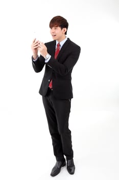 Young smart handsome Asian man business office wearing suit tie on white background looking at smartphone massage worried thinking photo