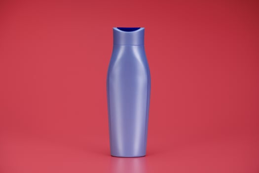 Purple Blank Label Shampoo Bottle or Shower Gel on Pink Background photo