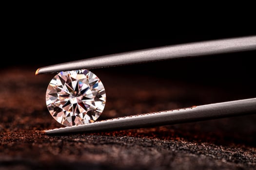 Round Cut Diamond Gemstone in Jewelry Tweezers photo