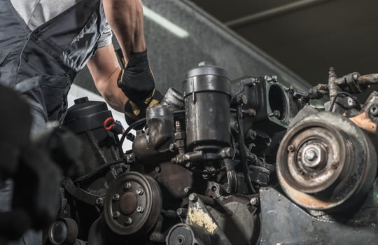 Diesel Specialist Automotive Mechanic Repairs the Engine photo
