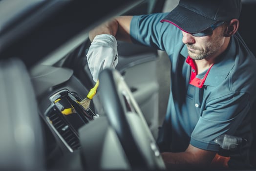 Automotive Worker Cleaning Modern Car Interior photo