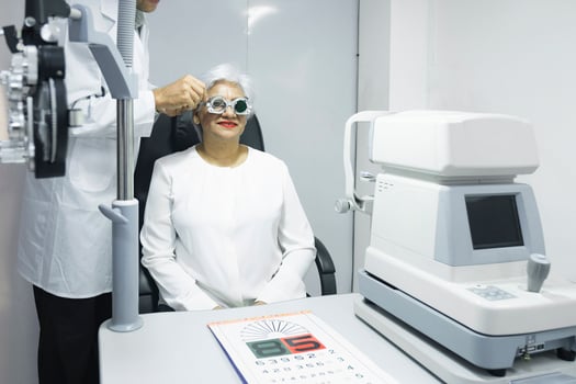 Woman examining eyesight in optical clinic. photo