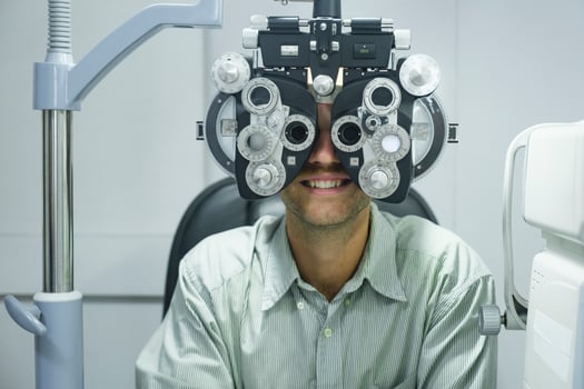 Man having eye test using phoropter. photo