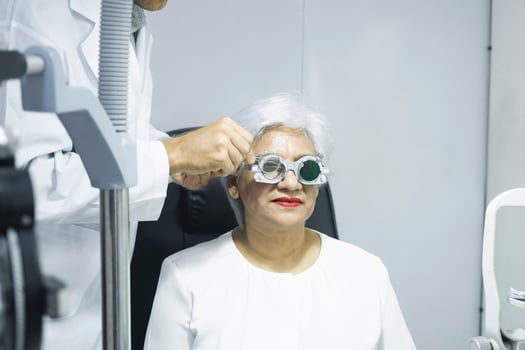 Woman examining eyesight in optical clinic. photo