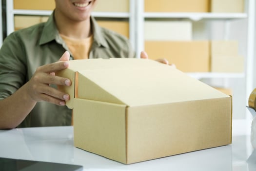 Young entrepreneur checking order preparing for delivery. photo