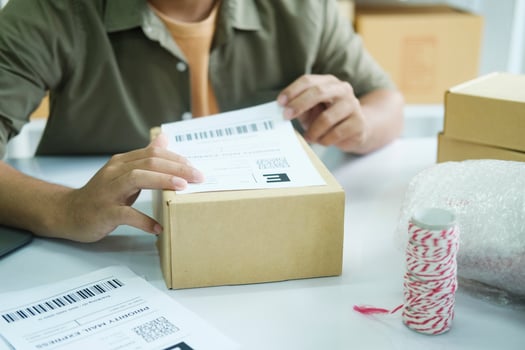 Young entrepreneur packing online order product for shipping. photo