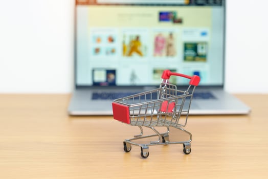 Shopping cart and laptop computer with marketplace website. Online Shopping, technology, ecommerce, SEO, Search Engine Optimization, Advertising, keyword and online payment concept photo