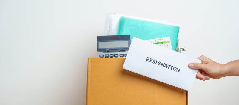 Resignation, Layoff, Unemployment, Dismiss, Job quit, Jobless and Farewell concept. Businesswoman holding letter of Resign contract with documents cardboard box at office photo