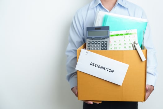 Resignation, Layoff, Unemployment, Dismiss, Job quit, Jobless and Farewell concept. Businessman holding letter of Resign contract with documents cardboard box at office photo