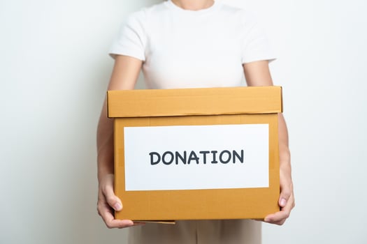 Donation, Charity, Volunteer, Giving and Delivery Concept. People donate Clothes and Food into Donation box at home or office for support and help poor, refugee and homeless people. Copy space photo