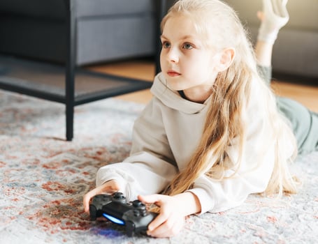 Girl playing video game at home photo