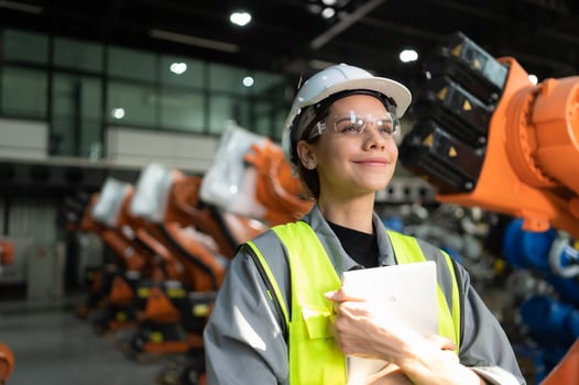 Portrait of female engineer with the mission of auditing, testing, improving software and calibrating robotics arm. photo
