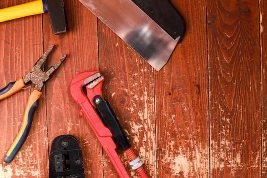 Flat lay Building tools  on wooden background. Pliers, hammer, clamp. Construction and repair photo