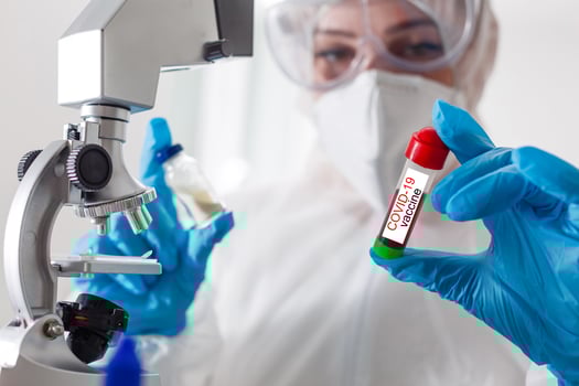 a man wearing a penis holding a covid 19 vaccine photo