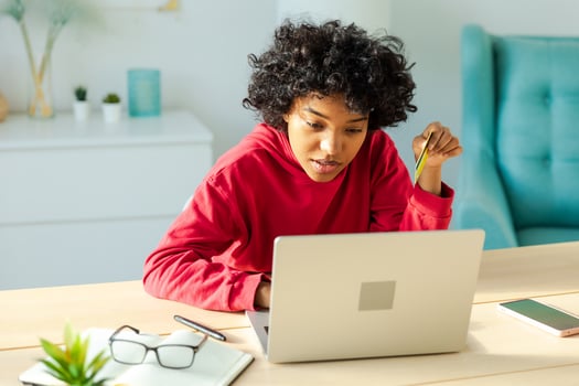 African american woman using laptop shopping online paying with gold credit card. Girl sitting at home buying on Internet enter credit card details. Online shopping ecommerce delivery service. photo