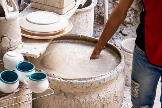 Barrel filled with mix for the clay injection molding technique in a traditional ceramics factory at the small city of Raquira in Colombia photo