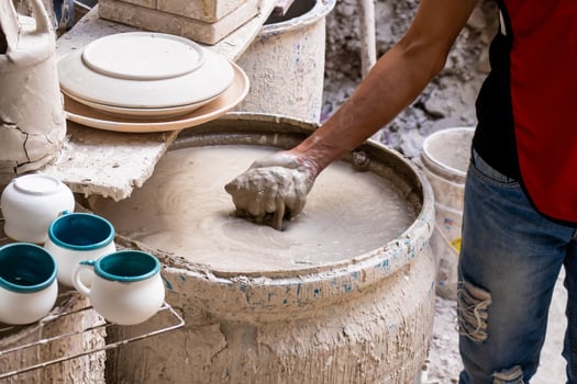 Barrel filled with mix for the clay injection molding technique in a traditional ceramics factory at the small city of Raquira in Colombia photo