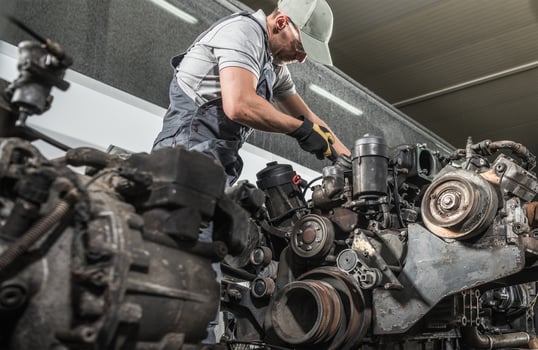 Truck Mechanic Rebuilding Truck Diesel Engine photo