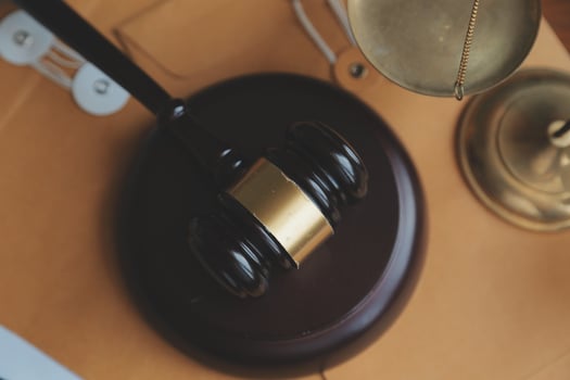 Business and lawyers discussing contract papers with brass scale on desk in office. Law, legal services, advice, justice and law concept picture with film grain effect photo
