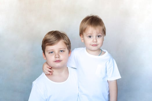 Boys-brothers in an embrace. Happy boys hug each other. Overjoyed, the best friends embrace. photo