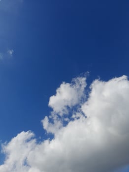 Beautiful white clouds on deep blue sky background. Large bright soft fluffy clouds are cover the entire blue sky. photo