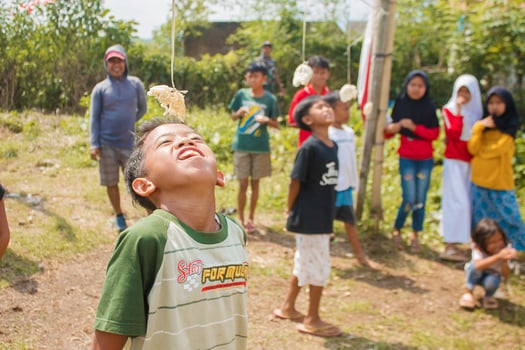 August 17, Tasikmalaya, West Java, Indonesia - Children taking part in a cracker eating competition, which is a form of celebrating Indonesian independence day on August 17 photo