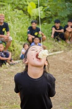 August 17, Tasikmalaya, West Java, Indonesia - Children taking part in a cracker eating competition, which is a form of celebrating Indonesian independence day on August 17 photo